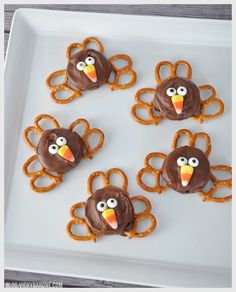 some pretzels are decorated like turkeys on a plate