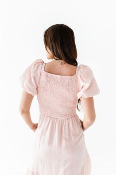 Features Square neckline Short puff sleeve with elastic Smocked bodice with stretch Elastic waist Bodice, sleeves, and skirt are lined Light pink with subtle textured gingham detail Pockets 84% Tencel, 16% Nylon; Lining: 100% Polyester Size + Fit Small 0-4, Medium 4-8, Large 8-12, X-Large 12-16, 1X 16-18, 2X 20-22, 3X 24-26 Kristin is 5'4", a size 1 and is wearing a Small Jaycie is 5'6" a size 18 and is wearing a 2X Runs true to size. Measurements taken while laying flat and then doubled. They d Gingham Short Sleeve Dress With Smocked Bodice, Cute Gingham Smocked Cotton Dress, Short Sleeve Gingham Smocked Dress, Gingham Cotton Dress With Lace Trim, Pink Short-sleeved Dress With Smocked Cuffs, Curvy Swim, Line Light, Light Pink Dress, Gingham Dress