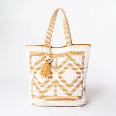 Bring a touch of boho style to your next picnic with this hand-loomed diamond pattern picnic tote. With a pom pom tassel detail and a generous 20" x 17" size, it's the perfect beach bag for all your picnic needs. Shell: 100% cotton. Lining: 100% polyester. FINAL SALE. Bohemian Beige Bags For Picnic, Beige Bohemian Bags For Picnic, Bohemian Square Beach Bag For Spring, Bohemian Straw Bag For Picnic, Bohemian Woven Bag For Picnics, Bohemian Beige Beach Bag For Picnics, Spring Bohemian Square Beach Bag, Bohemian Brown Bag For Picnic, Bohemian Tote Beach Bag With Tassels