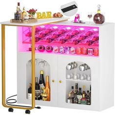 a white bar with pink lights and bottles on the top shelf is filled with liquor