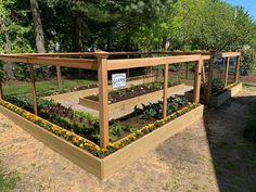 an outdoor garden area with raised wooden planters