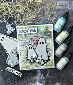 some crafting supplies are laying out on a table with ghost stickers and markers