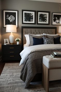 a bedroom with gray walls and pictures on the wall