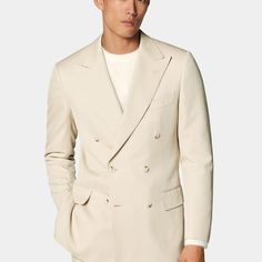 This sand suit is cut to a tailored fit with a slim chest, waist, and padded shoulders. Paired with wide-leg straight trousers featuring a high-rise and single pleat with belt loops. Beige Fitted Double Breasted Suit With Lapel Collar, Tailored Beige Suits With Lapel Collar, Beige Tailored Suits With Lapel Collar, Beige Double Breasted Suit For Business Casual, Tailored Beige Suit With Lapel Collar, Classic Beige Double Breasted Suit For Work, Tailored Beige Double Breasted Suit With Notch Lapel, Classic Fitted Double-breasted Pantsuit, Classic Fitted Pantsuit With Double Button Closure