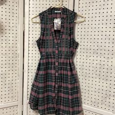 Pink,Black,And Green Plaid Mini Dress With Button Front,Belted Back Tie, Deep Front Plunge,And Front Embroidery Plaid Sleeveless Dress For Date Night, Sleeveless Plaid Dress For Date Night, Pink Dress With Buttons For Date Night, Pink Dress With Button Closure For Date Night, Sleeveless Plaid Dress With Button Closure, Plaid Sleeveless Mini Dress For Date Night, Sleeveless Plaid Mini Dress For Date Night, Casual Pink Shirt Dress For Dress Down Days, Casual Pink Shirt Dress For Dress Down Occasions