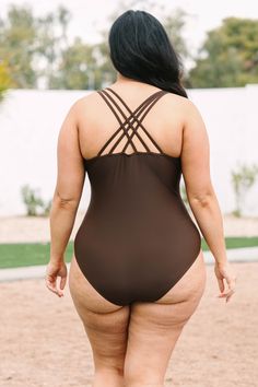 Throw on this fab swimmie and meet us at the lake! This cutie has an always fashionable brown color and three strand straps that cross over in the back for a super chic look! The slightly ruched sides are so stylish and the one piece style is so flattering! Style it with a cute kimono for an amazing swim look! 82% Polyamide, 18% Elasthane Brown Beachwear Swimwear With Adjustable Straps, Brown One-piece Swimwear For Beach, Brown One-piece Swimwear For Beach Season, Cross-tied Swimwear With Cross Back, Brown Lined Swimwear, Brown Lined Body Swimwear For Beach, Brown One-piece Swimwear For Pool, Brown Lined Swimwear For Pool, Brown Lined Swimwear For Beach