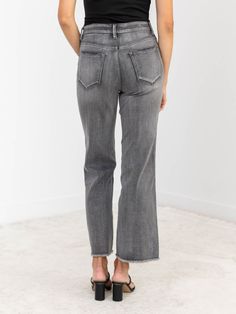 Unleash your inner fashionista with MICA's Dark Grey Super High Rise Wide Leg - featuring a trendy frayed hem, flattering high rise fit, and stretchy fabrication for ultimate comfort and style. Upgrade your wardrobe with these must-have grey wash jeans that boast a wide leg design. Grey Washed Color Wide Leg Opening Stretchy Fabrication High Rise Fit 32% Cotton, 34% Viscose Rayon, 32% Polyester, 2% Spandex. Rise: approx. 11" Inseam: approx. 29" Model is wearing a size 26. Fall Mid-rise Flare Jeans With Frayed Hem, Trendy Bottoms With Unfinished Hem For Fall, Denim Hoodie, Bridal Shower Outfit, Dressy Dresses, Style Upgrade, Viscose Rayon, Mother Denim, Grey Wash