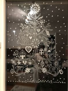 a christmas tree etched into a glass window