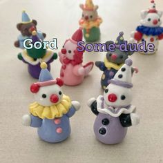 there are many small clown figurines on the table with words good and some dude