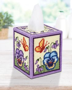 a tissue box decorated with flowers and butterflies