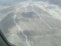 the view from an airplane window looking down on land