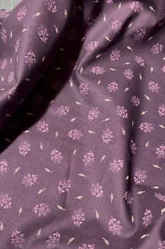 the fabric is purple and has white flowers on it