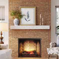 a living room with a fire place in the center and a painting on the wall