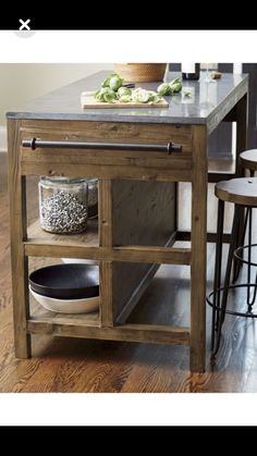 the kitchen island is made out of wood and has an open shelf for spices on it