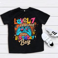 You are Viewing Gamer Birthday Boy Shirt, Personalized Birthday Shirt, Video Game Shirt, Birthday Boy Shirt, Birthday Party Shirt, Matching Family Shirt Please check the Shirt size charts by scrolling through the images. - The perfect shirt for your little ones birthday!! --- HOW TO ORDER --- 1. Select The Size 2. Select The Shirt Color 3. Add the customization details 4. Add to cart 5. Go back and Repeat for each size(if you need more than one shirt) - Stay class and unique with custom 100% cot Birthday Letter Print Graphic Tee Shirt, Birthday Graphic Tee With Letter Print, Birthday Letter Print Graphic Tee, Birthday Graphic Tee Shirt, Birthday Graphic Tee Shirt With Text Print, Graphic Tee Shirt With Text Print For Birthday, Birthday Shirt With Letter Print And Short Sleeves, Number Print Crew Neck Shirt For Birthday, Birthday Short Sleeve Graphic Tee Shirt