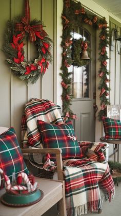 the front porch decorated for christmas with wreaths and plaid pillows