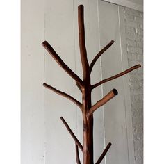 a wooden tree is hanging on the wall