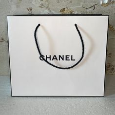 New Chanel Paper Bag 11.5”W X 10”H X 5”D Chanel Paper Bag Aesthetic, Chanel Paper Bag, Chanel Gift Bag, Chanel Shopping Bag Aesthetic, Chanel Mini Shopping Bag, Vanity Shelf, Chanel Black And White, Vanity Shelves, News Channels