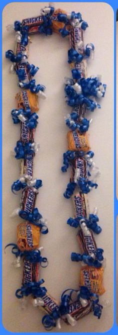 an image of candy bar necklaces made to look like the letter i in blue and white