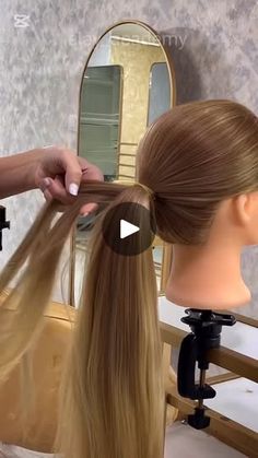 a woman is cutting her long blonde hair in front of a mannequin's head