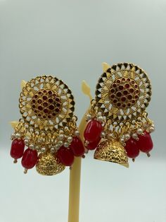 Beautifully crafted Meenakari Jhumki Earring embellished with stone and gold plated for a perfect addition to your jewelry set. Could be worn for every occasion - bridal wear, temple, and traditional events. This beautiful piece is one of a kind and will definitely elevate your fashion outlook. Earring Bridal, Jhumki Earrings, Kundan Earrings, Earring Gold, Traditional Wear, Bridal Earrings, Bridal Wear, Jewelry Set, Jewelry Earrings Dangle