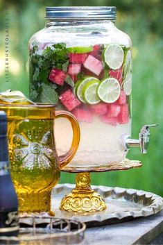 mason jar filled with watermelon, cucumber and limes on a tray