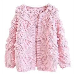 a pink knitted sweater with flowers on it