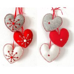 three felt heart ornaments hanging from strings on a white wall with red and silver decorations