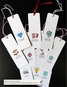 six tags with different designs on them hanging from string