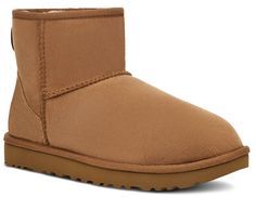 One of the most beloved silhouettes, the Classic Mini by UGG is an icon of casual style and comfort. Now pretreated to protect against moisture and staining, this beautiful sheepskin boot has also been updated with our Treadlite by UGG™ sole, which gives increased cushioning, durability, and traction on both wet and dry surfaces. Details  Twinface and suede Pretreated to repel water and stains UGGpure™ wool insole Treadlite by UGG™ outsole 5 ½” shaft height Ugg Mini Ii, Uggs Aesthetic, Classic Mini Ii Boot, Fake Uggs, Ugg Classic Mini Ii, Chestnut Uggs, Ugg Mini, Ugg Classic Mini, Exclusive Sneakers