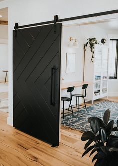 an open door leading to a dining room with chairs and tables in the back ground