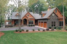 this is an image of a house in the country style with stone and wood accents