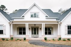 a white house with black shutters on the front