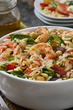 a white bowl filled with pasta salad and shrimp