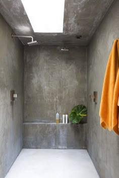 a bathroom with concrete walls and white flooring