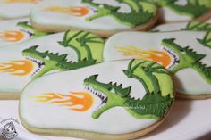 cookies decorated with green and orange designs on a white plate