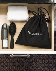 the contents of a hair dryer are neatly organized in a drawer next to a towel