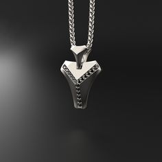 This magnificent pendant is composed of 18k white gold, includes 16 black diamonds and is completely handmade. A talisman stone is for those who want to know what life is all about. It will bring out all of your great qualities. The vertebrae that make up the human spine influenced its design. On a psychological level, this diamond represents what gives man the fortitude, bravery, drive, and unwavering belief to achieve his goals.Many people like white gold because of its silvery white hue, which gives it a refined appearance while also making it considerably more expensive than silver.White gold is impervious to rust, tarnish, and corrosion. White gold is more durable than yellow gold because it is alloyed with a combination of harder metals. Made entirely by hand with all the love and ar Silver Jewelry With Black Diamonds, Gift White Gold Jewelry With Black Spinel, Minimalist Silver Jewelry With Black Diamonds, White Gold Jewelry With Black Spinel For Gifts, Modern Black Diamond Jewelry, Minimalist Sterling Silver Jewelry With Black Diamonds, Modern Silver Jewelry With Black Diamonds, Modern Sterling Silver Jewelry With Black Diamonds, White Gold Black Spinel Jewelry For Gift