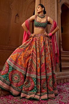 Orange, pink and green attached cancan lehenga with all over floral, mandala print, accentuated with heavy tassel strings with gota embroidery, hand adda work, beads and sequins embellishments. Paired with a padded blouse with all over quatrefoil print and sequin embellishments. Comes along with a dupatta with floral embroidered border.
Components: 3
Pattern: Print, Embroidery
Type Of Work: Floral, Mandala, Sequins, Beads
Neckline: Scoop Neck
Sleeve Type: Sleeveless
Fabric: Blouse and Lehenga: R A Line Lehenga, Choli Dress, Lehenga Dupatta, Lehenga Choli Online, Multi Color Blouse, Wedding Saree Indian, Half Sleeve Blouse, Designer Lehenga Choli, Chaniya Choli