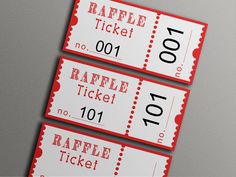 three red and white raffle tickets sitting on top of each other