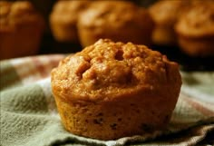 a muffin sitting on top of a green towel next to other muffins