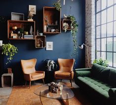 a living room filled with furniture next to a large window covered in potted plants