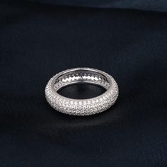 a white gold and diamond ring on a black background