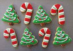 decorated christmas cookies arranged in the shape of trees