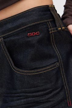 The ultimate pair of effortless boyfriend jeans from BDG. Super relaxed and baggy fit throughout with a low-rise and a wide-leg silhouette. Made using recycled materials and finished with a BDG logo at the back pocket. Find it exclusively at Urban Outfitters. Features BDG Jaya baggy boyfriend jeans Extreme baggy jeans Crafted from rigid BDG denim made using recycled materials Low rise that sits at the hip Full length with a puddled hem Zip fly; 5-pocket styling UO exclusive Content + Care 80% Co Dark Blue Baggy Jeans, Dark Denim Jeans Outfit, Baggy Boyfriend Jeans, Denim Jeans Outfit, Bday List, Low Waist Jeans, Bdg Jeans, Jean Crafts, Boyfriend Jean