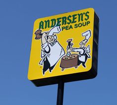 a yellow sign with an image of a chef cooking on it's side and the words anderson's pea soup above it