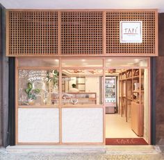 the front entrance to tari, a japanese restaurant with wooden doors and windows that have writing on them