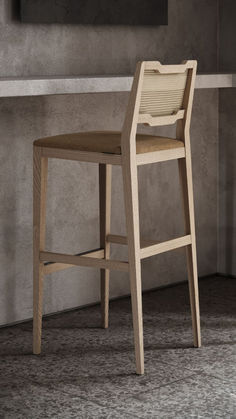 a wooden bar stool sitting in front of a wall with a painting on the wall behind it