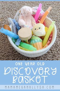 a basket filled with toys on top of a carpet next to the words, one year old discovery basket