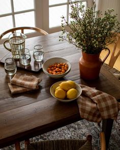 a wooden table topped with plates and bowls of food